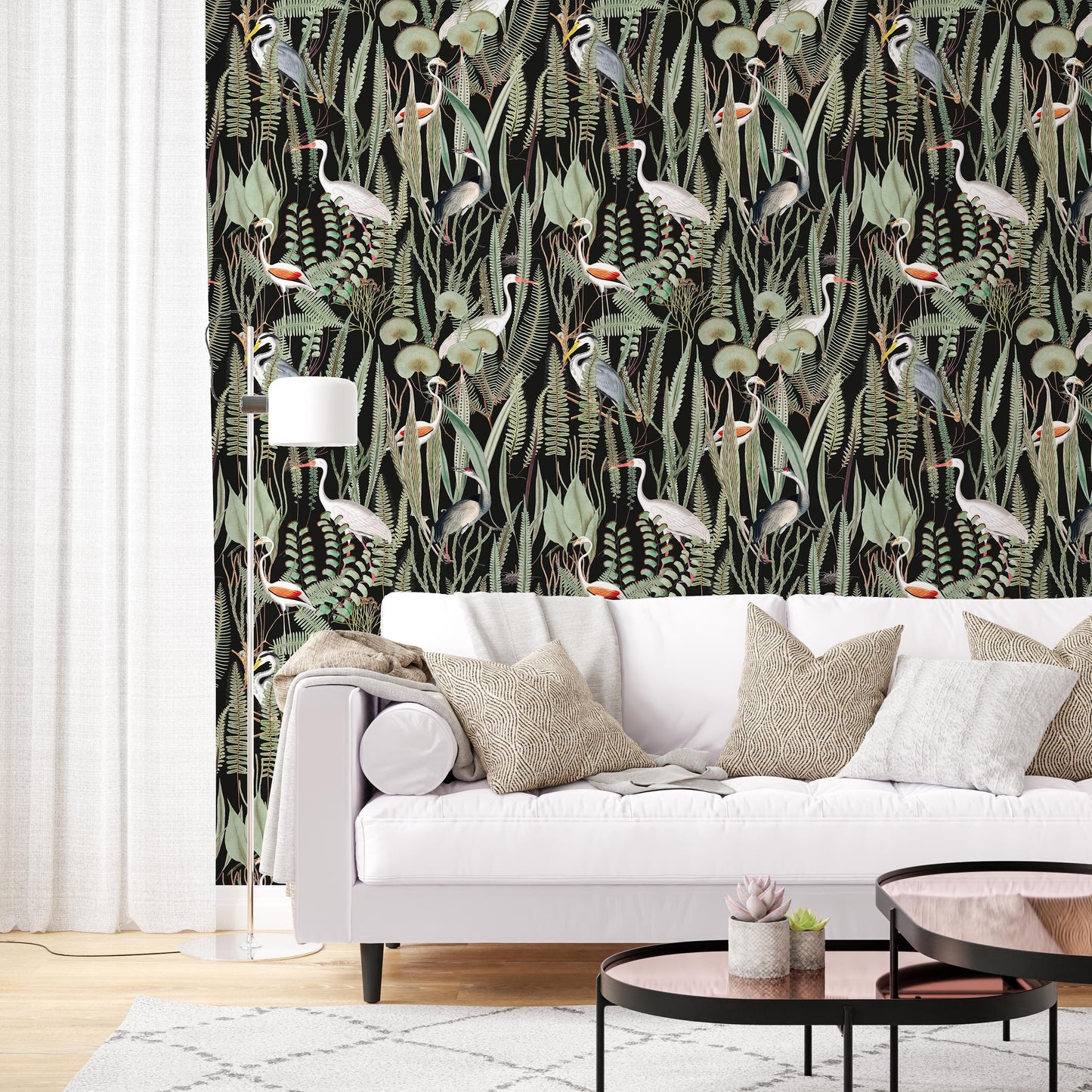 Elevate your living room with our striking black background heron and botanical wallpaper. The sophisticated black backdrop complements the crisp white couch and linen accents, creating a harmonious blend of elegance and comfort. The intricate floral patterns and majestic herons add a touch of visual intrigue, transforming your living room into a captivating centerpiece.
