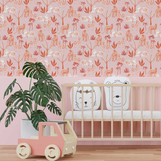 Pink nursery with a half wall painted pink and the upper half featuring modern safari wallpaper.